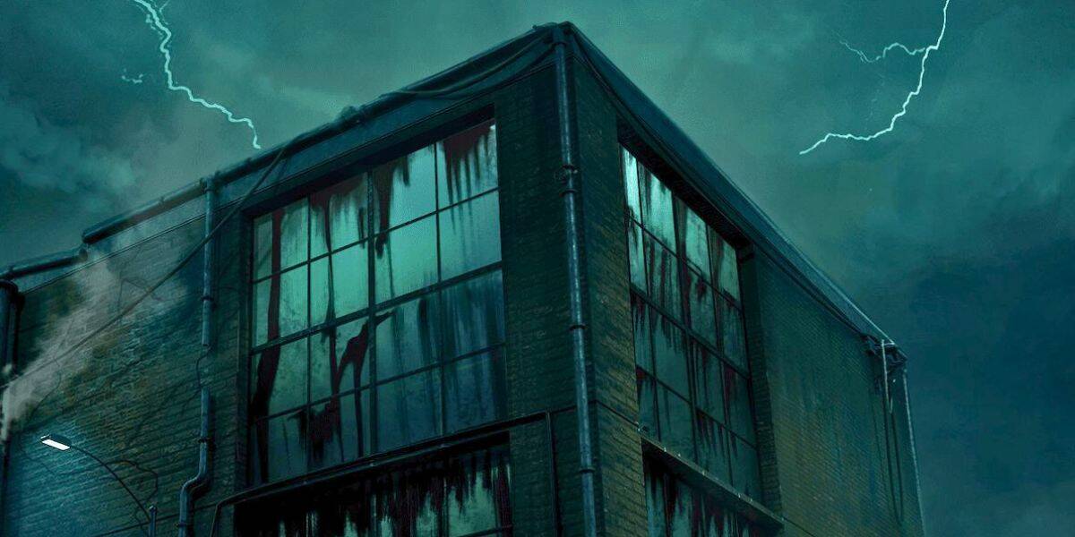 A dark, abandoned building with cracked windows and streaks of grime stands under a stormy night sky, illuminated by lightning bolts in the background as Universal Chicago prepares for Horror Unleashed.