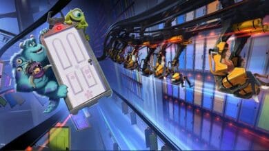 Animated characters Sulley, Mike, and Boo from Monsters, Inc. hold a door while a roller coaster with riders speeds past them through a colorful tunnel filled with floating doors.