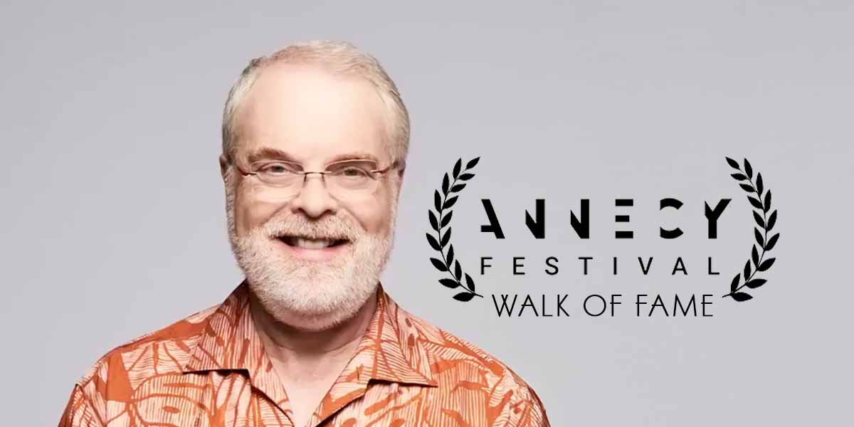 A smiling man with white hair, beard, and glasses wears an orange patterned shirt. Next to him is a laurel wreath graphic with the text "Annecy Festival Walk of Fame.