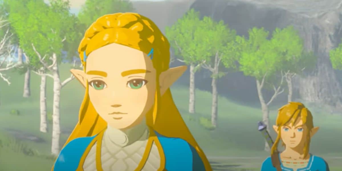 Two characters with pointed ears and blue clothing stand in a green, wooded area. The character in front has long blond hair and looks thoughtful, while the second character stands behind with a bow on their back.
