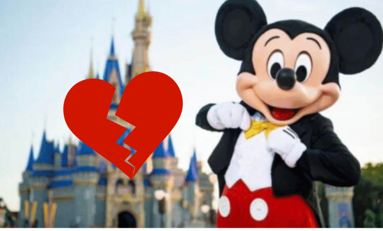 Mickey Mouse stands in front of Cinderella Castle with a broken heart overlay
