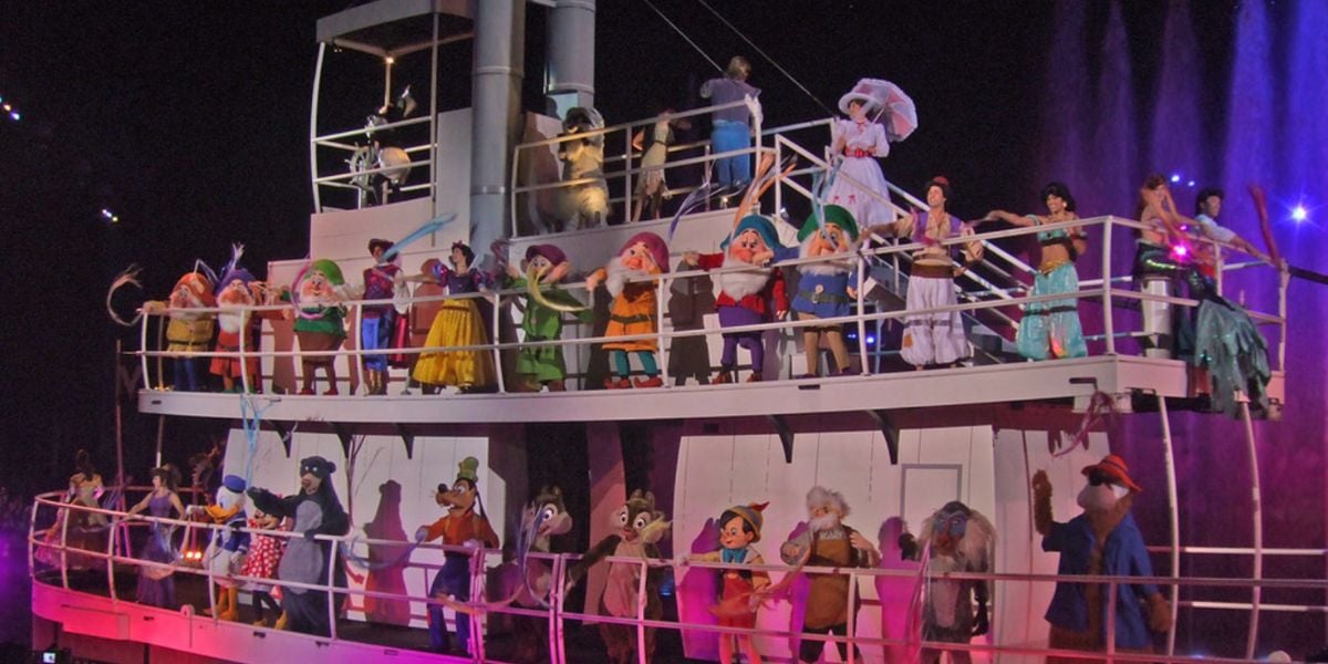A large group of Disney characters on a boat in the finale of Fantasmic!