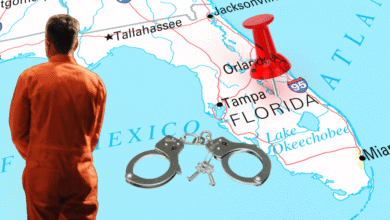 A man in an orange jumpsuit faces a map of Florida, with a red pushpin marking the state and a pair of handcuffs and keys placed over the map near Tampa and Orlando.