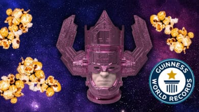 A large purple robotic head floats in a starry galaxy background, surrounded by clusters of caramel popcorn. A Guinness World Records logo appears in the lower right corner.