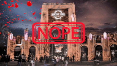 A crowd stands outside Universal Studios at night with Halloween Horror Nights banners. Red blood splatter and a large red "NOPE" stamp overlay the image. The sky is dark and dramatic.