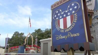 A sign at Disney Parks reads "Celebrate the American Dream" as thousands of immigrants take the Oath of US Citizenship at Walt Disney World Resort on July 4, 2007.