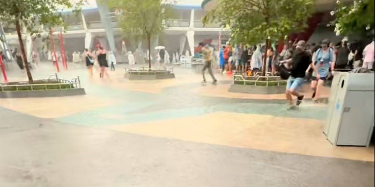 People walking through a flooded Tomorrowland in Magic Kingdom