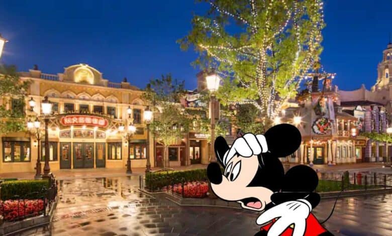 A worried-looking Mickey Mouse in front of stores at Shanghai Disneyland at nighttime