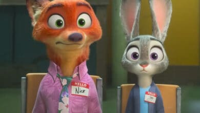 A cartoon fox in a pink shirt and a rabbit in blue sit side by side, both wide-eyed, wearing name tags: "Nick" and "Judy." It's a scene that feels straight out of the Zootopia 2 trailer.