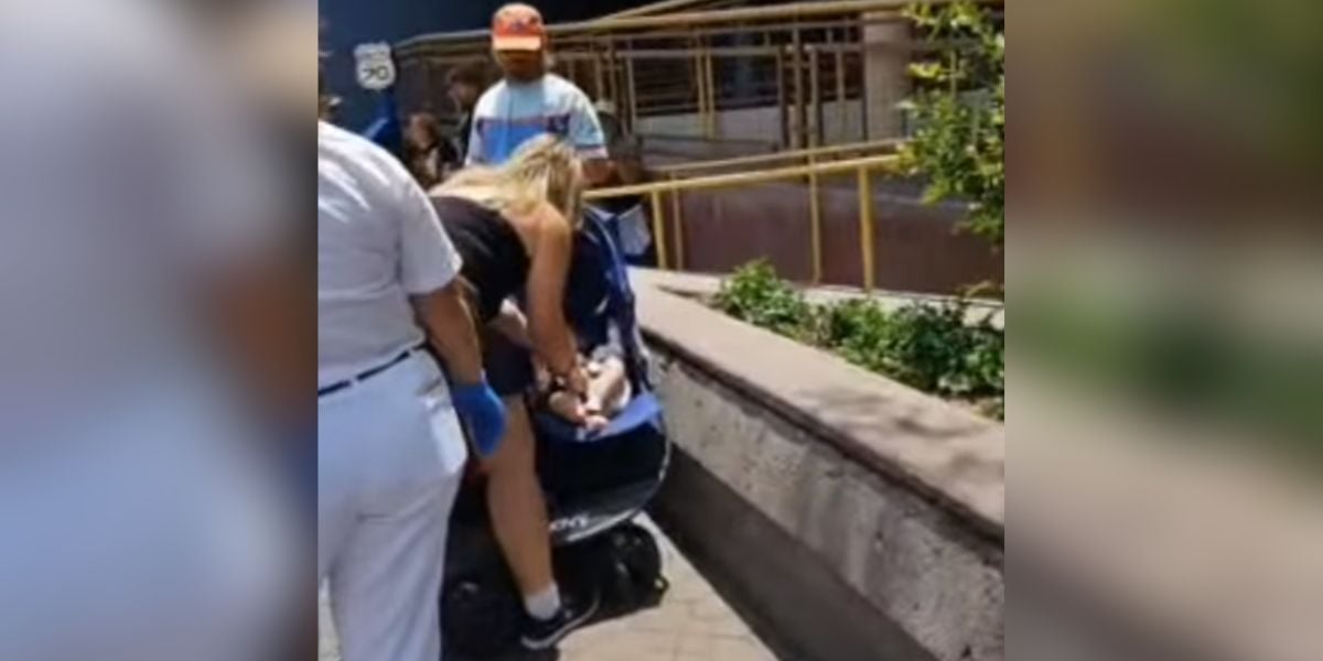 A woman interacting with a baby who was left in a stroller at Disneyland.