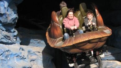 Two people riding Crush's Coaster at Disneyland Paris.
