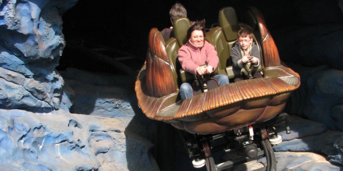 Two people riding Crush's Coaster at Disneyland Paris.