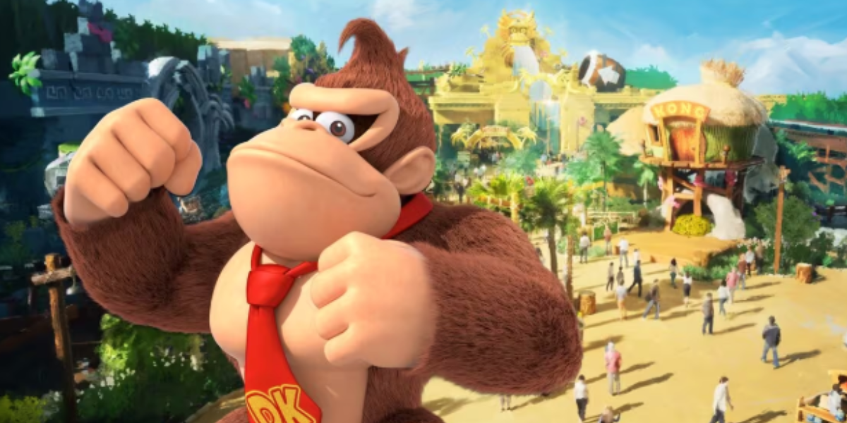 Donkey Kong stands confidently with fists raised in front of a vibrant, tropical-themed amusement park featuring jungle scenery, a banana-shaped building, and people exploring the attractions.