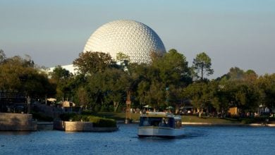 A FriendShip ferry boat on the World Showcase Lagoon at EPCOT. Spaceship Earth is in the background.