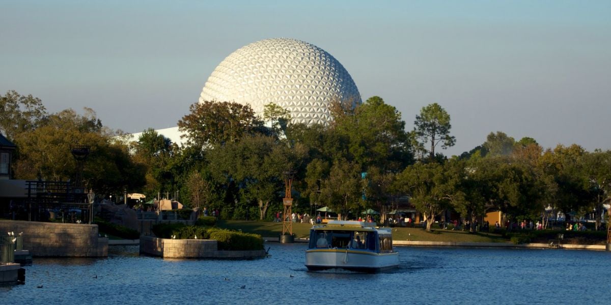 A FriendShip ferry boat on the World Showcase Lagoon at EPCOT. Spaceship Earth is in the background.