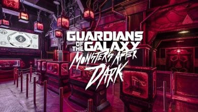 Futuristic, neon-lit room with "Guardians of the Galaxy: Monsters After Dark" logo in bold white text overlay. Queue stanchions and themed sci-fi decor fill the space. Large screen and industrial lights are visible.