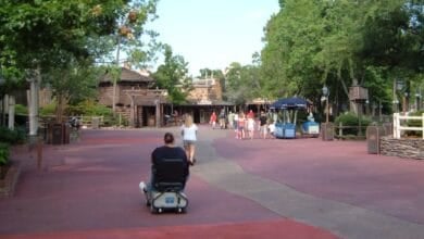 People walking through Frontierland at Magic Kingdom Park.