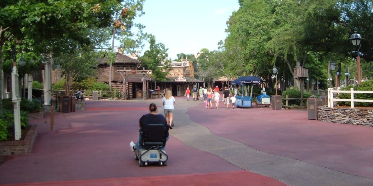 People walking through Frontierland at Magic Kingdom Park.