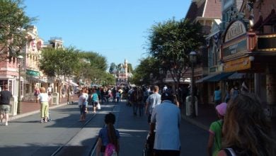 Crowds of people walk down Main Street, U.S.A. at Disneyland Park