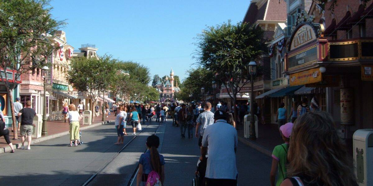 Crowds of people walk down Main Street, U.S.A. at Disneyland Park