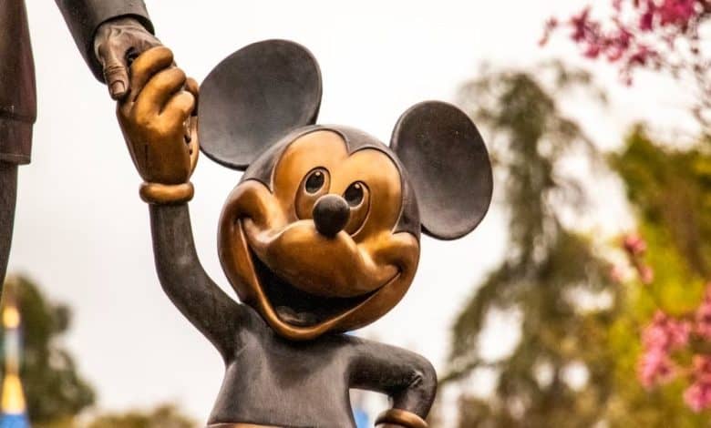 statue of Mickey Mouse smiling and holding hands with Walt Disney
