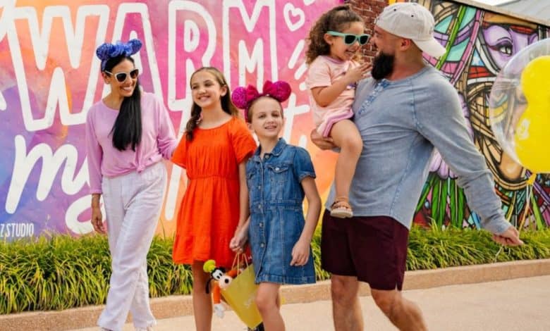 A family strolls through Disney Springs to shop