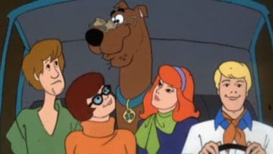 Five animated characters, including a large brown dog wearing a blue collar, sit together in a car—giving off serious Stranger Things vibes—as four humans sit up front and the dog stays in the middle, all looking ahead and smiling.