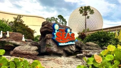 Sign for The Seas With Nemo and Friends ride in Disney World's EPCOT With Spaceship Earth in the background