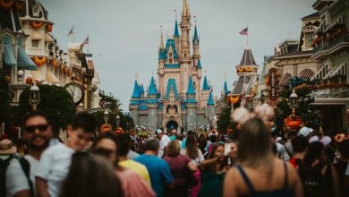 A large crowd of people on Main Street, U.S.A. with Cinderella Castle in the background