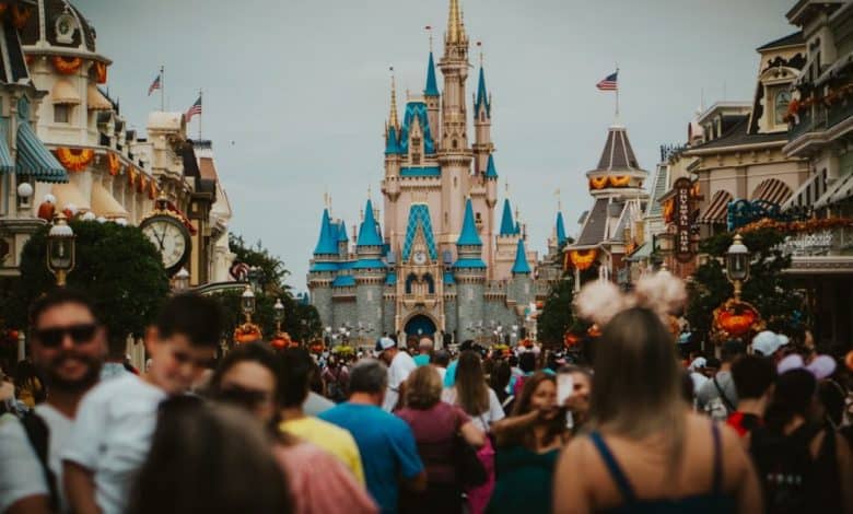 A large crowd of people on Main Street, U.S.A. with Cinderella Castle in the background