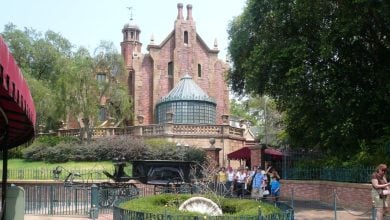 The hearse and exterior of the Haunted Mansion at the Magic Kingdom.
