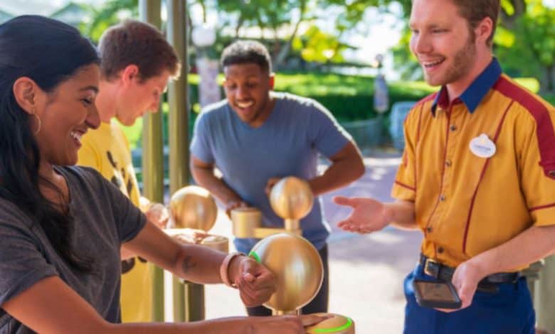 guest scans MagicBand at Disney World to use lightning lane pass. Disneyland MagicBand+ ending