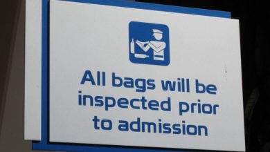 A Disney security sign at EPCOT reads "All bags will be inspected prior to admission."