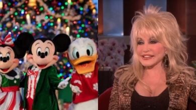 Minnie Mouse, Mickey Mouse, and Donald Duck in festive outfits stand by a Christmas tree; next to them, a woman with blonde hair and a sparkly jacket smiles during a TV interview.