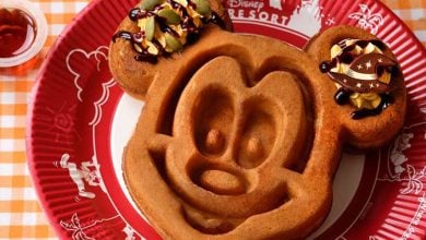 A Mickey Mouse-shaped waffle on a red plate from Tokyo Disney Resort
