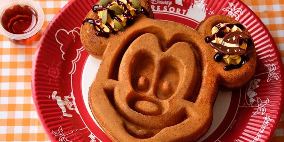 A Mickey Mouse-shaped waffle on a red plate from Tokyo Disney Resort
