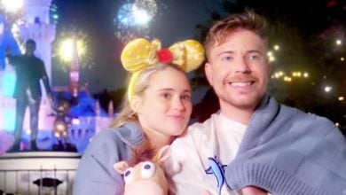 Mr. Beast and his fiance in front of the Partners Statue at Disneyland theme park.