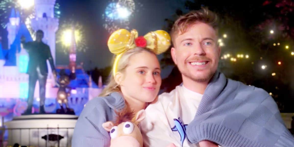 Mr. Beast and his fiance in front of the Partners Statue at Disneyland theme park.
