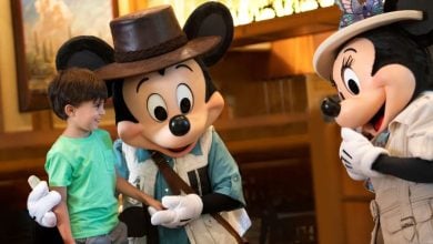 A young boy meets Mickey Mouse and Minnie Mouse at Storyteller's Cafe