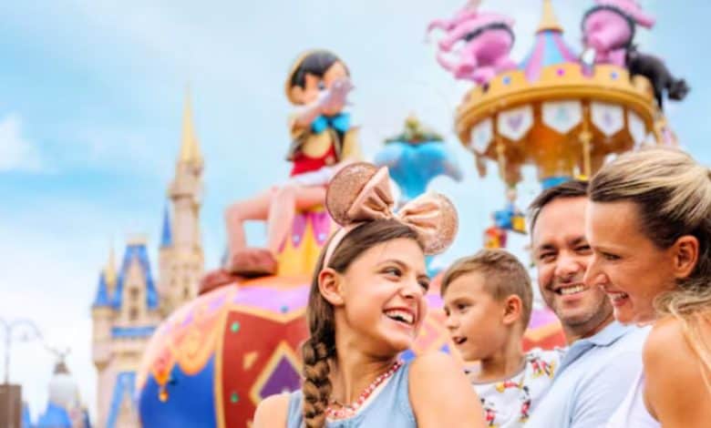 family at disney world's magic kingdom as festival of fantasy parade passes in the background
