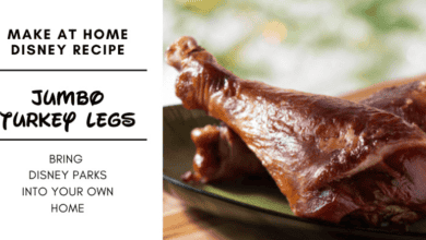 Close-up of two cooked jumbo turkey legs on a plate, with text promoting a Disney turkey leg recipe to make at home: “Jumbo Turkey Legs—Bring Disney Parks into your own home.”.