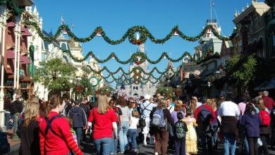 Guests stroll down Main Street, U.S.A. at Magic Kingdom, at Christmas.