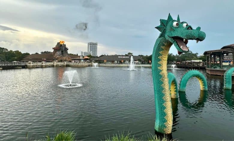 The iconic green LEGO sea serpent emerges from the Disney Springs lake.