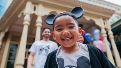 young guest smiling while wearing mickey ears at Disney World