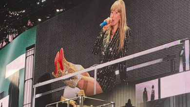 Taylor Swift puts her feet up while on The Eras Tour stage