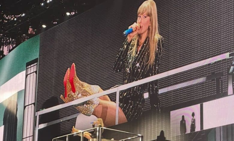 Taylor Swift puts her feet up while on The Eras Tour stage