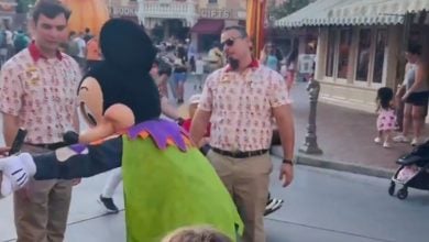 Mickey Mouse taking a phone from a father.