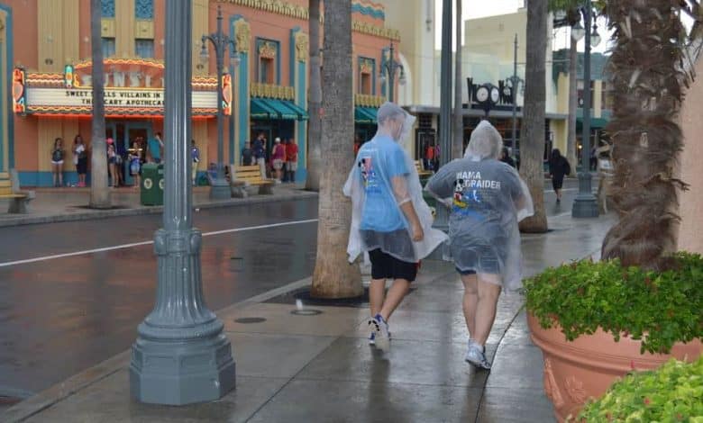 Guests in rain ponchos on Sunset Boulevard at Disney's Hollywood Studios.
