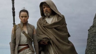 Rey with Luke Skywalker in front of the ocean