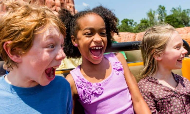three younger guests ride Big Thunder Mountain in Disney World's Magic Kingdom park